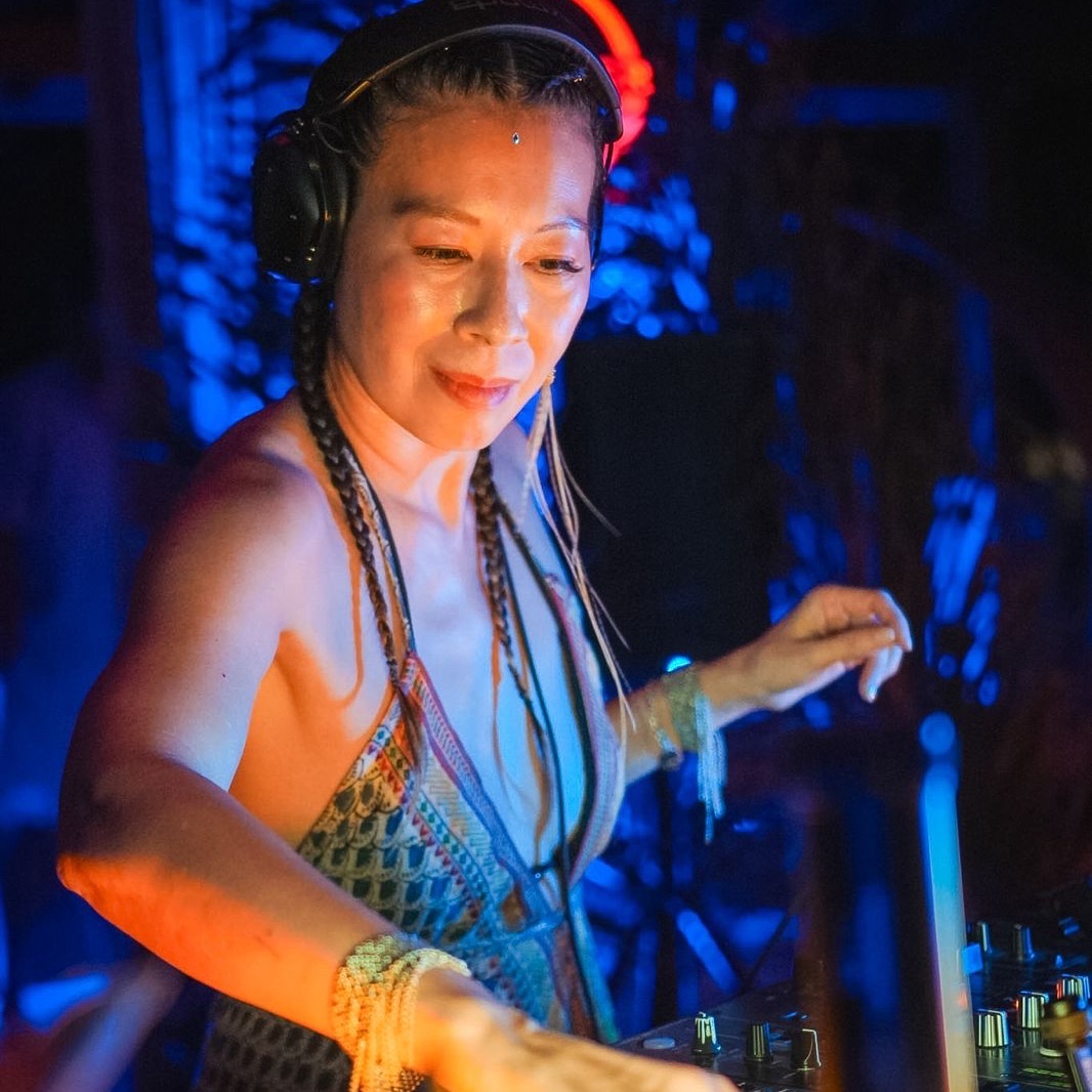Lea DJing under blue light