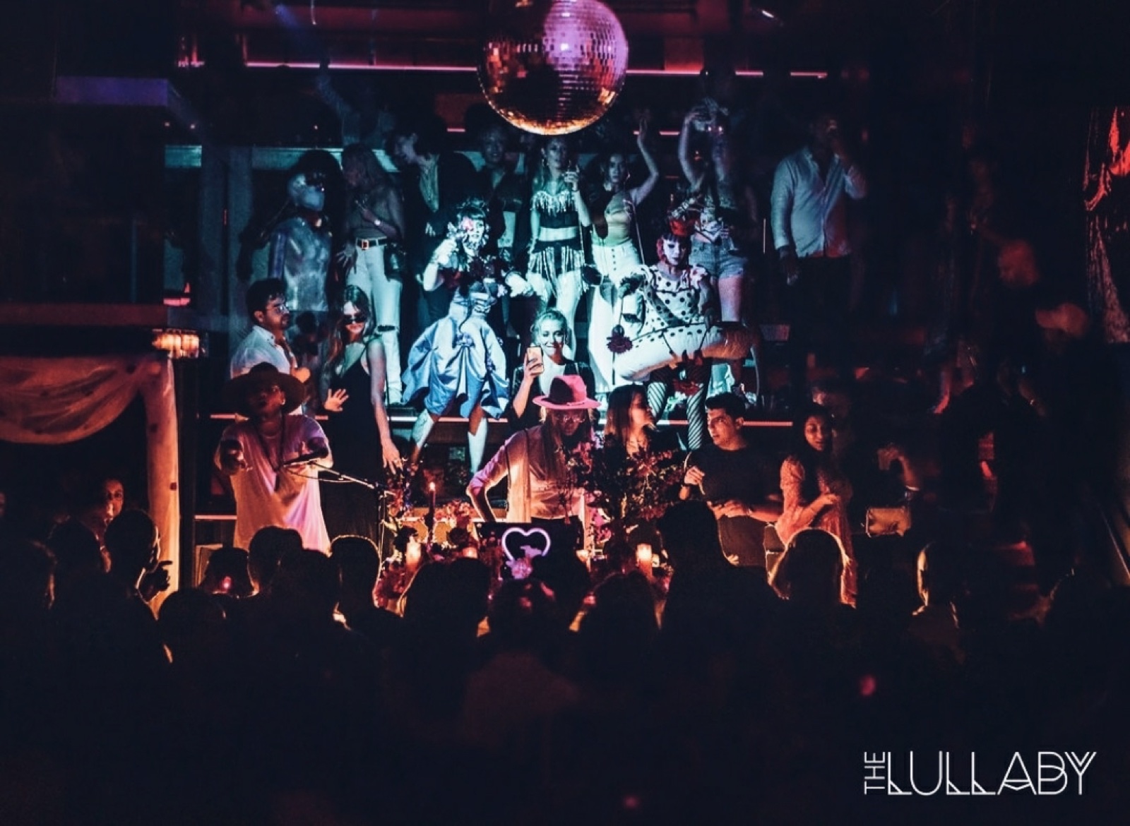 Olga Cerpita DJing at The Lullaby beneath the disco ball
