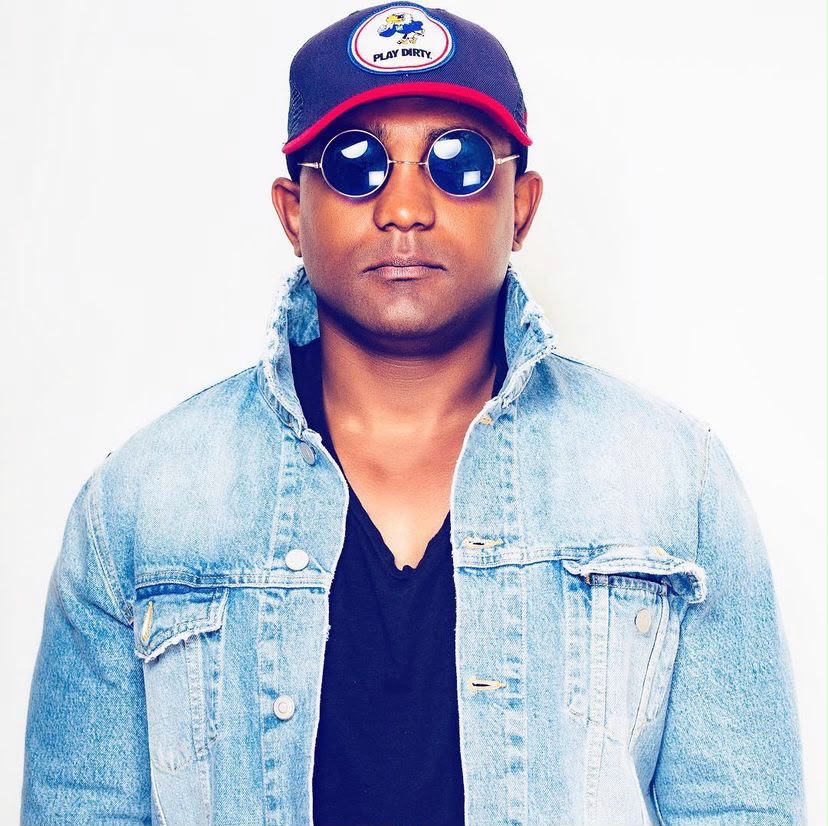 DJ Ricardo Lima — denim jacket and round sunglasses